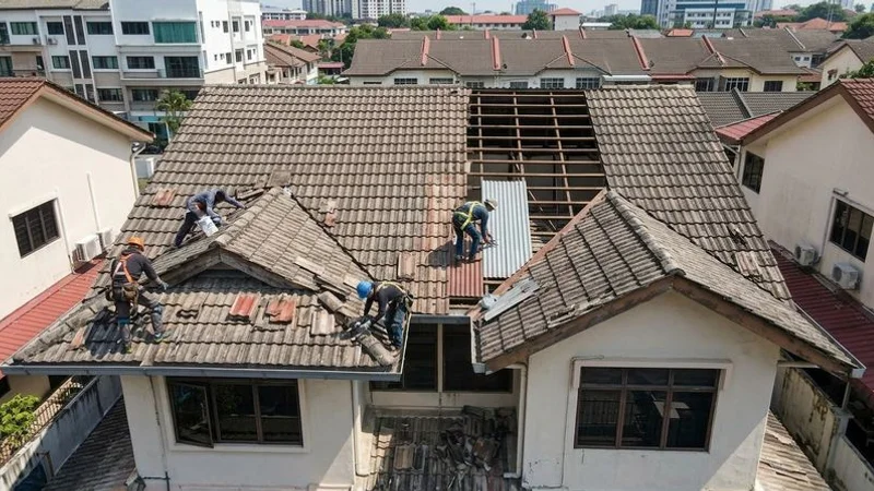 Aerial photograph of aged concrete tile roof on a double-storey terrace house in Kuala Lumpur showing widespread wear and deterioration
